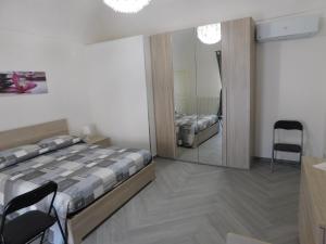Postel nebo postele na pokoji v ubytování Palazzo dei Vespri