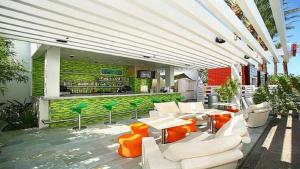 a patio with a bar with white chairs and tables at Palms Place Beautiful 51st Floor with Mountain Views in Las Vegas