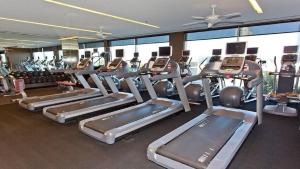 a gym with a bunch of treadmills and machines at Palms Place Beautiful 51st Floor with Mountain Views in Las Vegas
