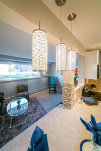 a living room with three chandeliers at McKinnon Pointe #102 in Edmonton