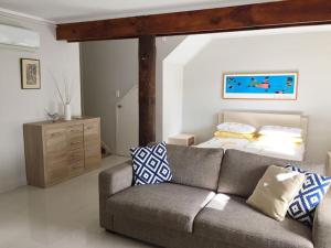 a living room with a couch and a bed at Titirangi Paradiso in Titirangi