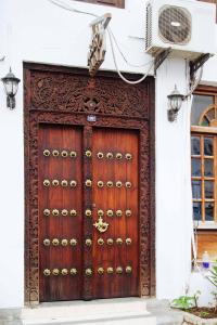 a large wooden door on the side of a building at Abuso Inn in Zanzibar City