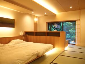 Кровать или кровати в номере Yoshimatsu