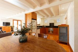 a kitchen and living room with a wooden table at 54 on Bank in Port Fairy