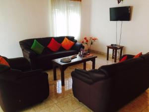a living room with a couch and a table at Sleep Cheap Home in Negombo