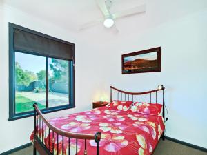 a bedroom with a bed and a large window at Sea Devine - Port Willunga - C21 SouthCoast Holidays in Port Willunga