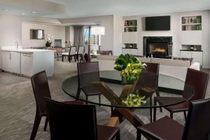 a dining room and living room with a table and chairs at Hyatt Regency Bethesda near Washington D.C. in Bethesda