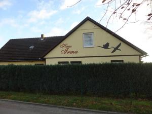 a house with a bird painted on the side of it at Haus Irma in Zingst