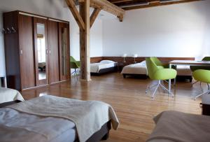 a bedroom with two beds and a table and chairs at Hotel Młyn Toruń - dawne MCSM in Toruń +47 photos