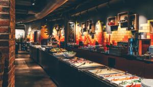 a buffet line with many plates of food at Original Sokos Hotel Villa Tampere in Tampere