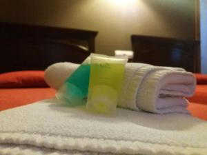 a stack of towels and a candle on a bed at Hospedería Prepirineo in Undués-Pintano