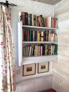 a row of books on shelves on a wall at FeWo Heitmann in Oberjoch