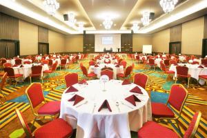 a large room with tables and chairs in it at Hotel Grand Zuri Muara Enim in Muaraenim