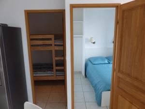 a bedroom with a bunk bed and a door leading into a room at Appartement face à la mer in La Croix-Valmer