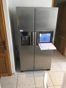 a stainless steel refrigerator with a computer on top of it at Appartement face à la mer in La Croix-Valmer