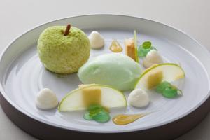 a white plate with an apple and other food on it at Strandhotel Fontana in Timmendorfer Strand