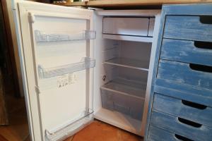 an empty refrigerator with its door open in a kitchen at Au Pied du Château in Gréolières les Neiges +19 photos