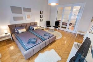 a living room with a couch and a television at BrightHome Castle District in Budapest