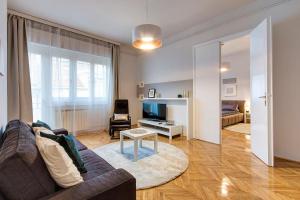 a living room with a couch and a table at BrightHome Castle District in Budapest