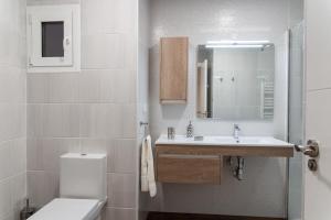 a white bathroom with a sink and a toilet at El Horno de los Bizcochos in Toledo +16 photos