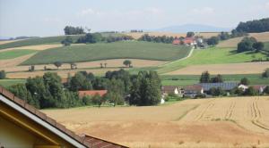 a view of a farm with fields and trees at Ferienwohnung "Bäderdreieck" in Haarbach