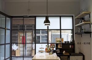 a kitchen with a large window and a table at Ho.Me-Easyhouse in Tainan