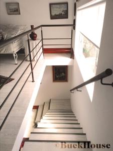 a staircase in a house with a bed and a window at Buckhouse Elegant Village Apartment in Heidelberg +20 photos