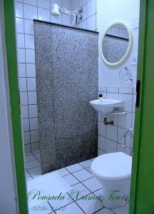 a bathroom with a shower with a toilet and a sink at Pousada Xamã Tour in João Pessoa