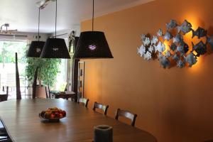 a dining room table with a bowl of fruit on it at B&B Le Perchoir in Libin