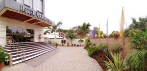 a building with a staircase in front of a store at Hotel Karan Vilas in Agra