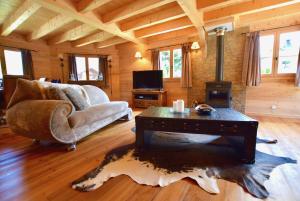 a living room with a couch and a table at Chalet Imperial in Morzine