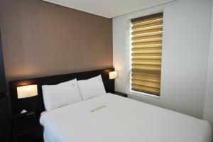Postel nebo postele na pokoji v ubytování MS Hotel Haeundae