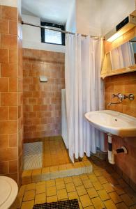 a bathroom with a shower curtain and a sink at Bungalovy FIS Economy in Štrbské Pleso