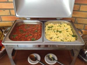 two trays of food on top of a stove at CostaSol Pipa Chalés in Pipa