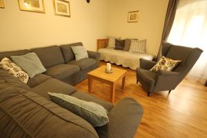 a living room with a couch and chairs and a table at Apartmány Scharffenberg in Banská Štiavnica