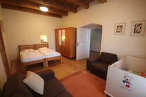 a small living room with a bed and a couch at Apartmány Scharffenberg in Banská Štiavnica