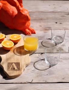 una mesa de madera con vasos de zumo de naranja. en InAweStays Holiday Homes, en Ciudad del Cabo