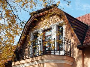 a building with a balcony on top of it at Villa Rosa in Dunajská Streda