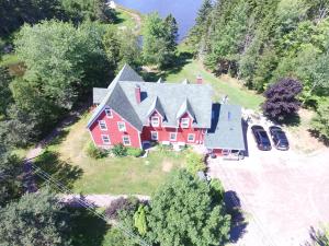 an aerial view of a large red house with a driveway at Little Shemogue Inn in Little Shemogue