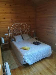 1 dormitorio con 1 cama con pared de madera en Villas Eldorado-Mascotas Bienvenidas, en Barreiros