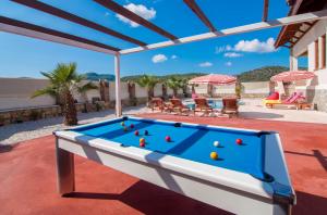 a pool table on the patio of a house at Smans Villas in Oludeniz