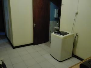 a bathroom with a trash can in a room at Maison Au pied du Volcan in Curepipe