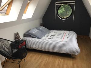 a small bedroom with a bed and a window at Amiens LOFT in Amiens