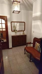 a living room with a mirror and a couch at LUCINDA`S HOUSE in Braga