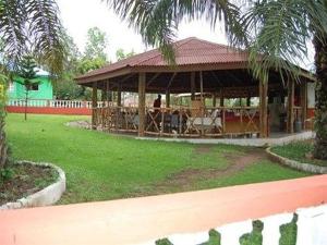 a pavilion with a table and chairs in a park at Konkon Wonderland in Accra