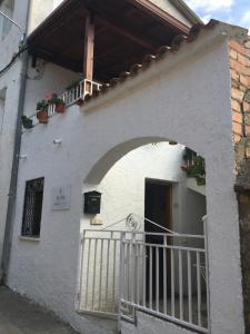 an entrance to a white building with a gate at Ruralfranxuli in Avellanes