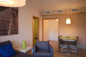 a living room with a table and chairs at Lets Holidays New Flat Beachfront In Castelldefels in Castelldefels