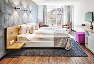 Postel nebo postele na pokoji v ubytování Seevital Hotel & SPA - Ihr 4 Sterne Superior Hideaway direkt am See