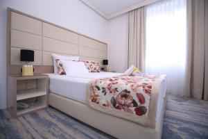 una camera da letto con un letto grande e una finestra di Old Town Hotel a Sarajevo