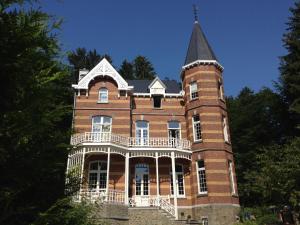 a large brick building with a tower at Villa Grand Maur in Spa